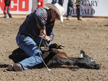 Tuf Cooper of Weatherford, Texas,  puts the loops on his calf to win the Tie Down Roping final in the Stampede Rodeo at the Calgary Stampede in Calgary, Ab., on Sunday July 15, 2018. Mike Drew/Postmedia