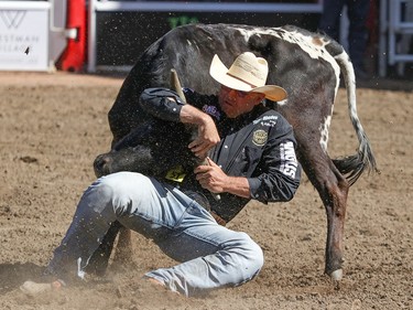 Matt Reeves, Cross Plains, Texas,  twists his steer to win the Steer Wrestling final in the Stampede Rodeo at the Calgary Stampede in Calgary, Ab., on Sunday July 15, 2018. Mike Drew/Postmedia