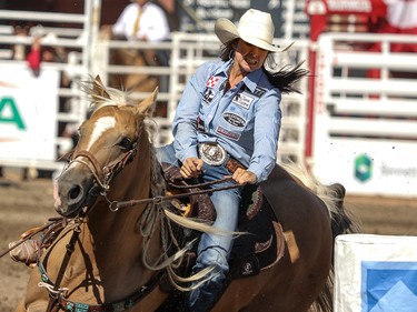 Hailey Kinsel, Cotulla, Texas, and Sister on their way to winning the Barrel Racing final in the Stampede Rodeo at the Calgary Stampede in Calgary, Ab., on Sunday July 15, 2018. Mike Drew/Postmedia