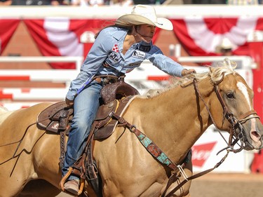 Hailey Kinsel, Cotulla, Texas, and Sister on their way to winning the Barrel Racing final in the Stampede Rodeo at the Calgary Stampede in Calgary, Ab., on Sunday July 15, 2018. Mike Drew/Postmedia