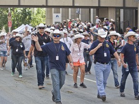 First responders to the Humboldt Broncos bus crash march at the 2018 Calgary Stampede Parade on July 6, 2018. (Zach Laing / Postmedia Network)