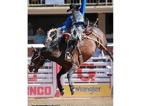 Ryder Wright from Milford UT rides Rise and Shine to a the day's top score of 90 points in the saddle bronc event at the Calgary Stampede rodeo on Thursday July 12, 2018. Gavin Young/Postmedia