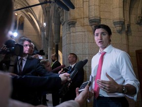 In this file photo taken on June 13, 2018 Canadian Prime Minister Justin Trudeau speaks with the media on Parliament Hill in Ottawa, Ontario.