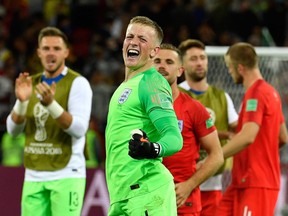 England's goalkeeper Jordan Pickford and teammates celebrate after winning the penalty shootout at the end of the Russia 2018 World Cup round of 16 football match between Colombia and England at the Spartak Stadium in Moscow on July 3, 2018.