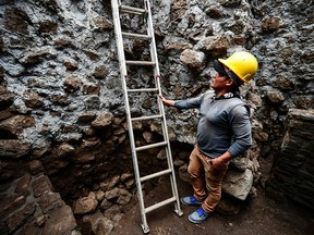 A man works at the substructure inside the Teopanzolco pyramid in Cuernavaca, Morelos State, Mexico on July 11, 2018.