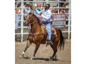 Texas cowboy Cory Solomon makes the victory lap after posting a time (6.9 seconds) on Day 1 of the tie-down roping event during the 2018 Calgary Stampede on Friday, July 6, 2018. Al Charest/Postmedia