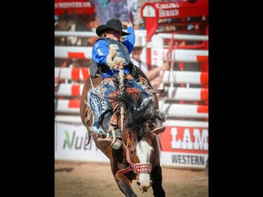 Ryder Wright of Milford, Utah rides Stampede Warrior to a score of 93 in the Saddle bronc riding event on Championship Sunday during the 2018 Calgary Stampede on Sunday, July 15, 2018. Al Charest/Postmedia