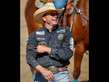 Matt Reeves of Cross Plains, Texas celebrates after planting his steer in a time of 4.7 seconds in the steer-wrestling event on Championship Sunday ?at the 2018 Calgary Stampede on Sunday, July 15, 2018. Al Charest/Postmedia