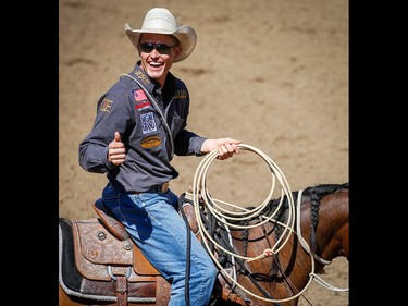 Texas cowboy Tuf Cooper celebrates after posting a time (6.8 seconds) in the tie-down roping event on Championship Sunday during the 2018 Calgary Stampede on Sunday, July 15, 2018. Al Charest/Postmedia