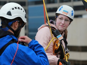Postmedia reporter Anna Junker tries the Make-A-Wish Rope for Hope rappel on the Barclay Building in downtown Calgary on Tuesday July 3, 2018. Gavin Young/Postmedia