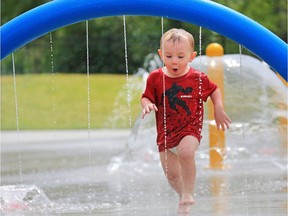 Two year-old Hunter has some fun cooling off in the water park at Rotary Park in Calgary on Thursday July 19, 2018.  Gavin Young/Postmedia