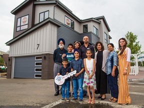 Karanbir Sidhu, centre, from Calgary stands with family in front of the 2018 Rotary Dream Home he won in the 2018 Calgary Stampede lotteries. Prize winners were presented with their prizes on Tuesday July 24, 2018. New this year Sidhu also won a cheque for $100,000. The dream home will soon be moved to the community of Walden. Gavin Young/Postmedia