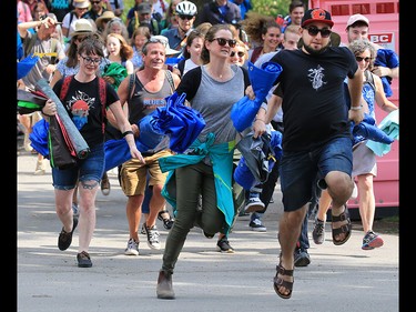 Fans race to set up their tarps at the start of the Calgary Folk Festival on Prince's Island on Thursday July 26, 2018.