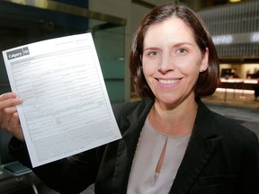Brandy MacInnis, senior special projects officer with the City of Calgary, holds a cannabis business application at the licensing offices at city hall. MacInnis was photographed on April 24.