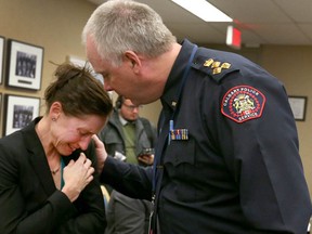 A tearful Jen Ward cries and is comforted by Police Chief Roger Chaffin after she resigned her position of a Calgary Police Service officer in Calgary, Alta on Tuesday January 31, 2017. Ward stood in front of the Police commission and cited bullying and harassment as the reasons for her resigning her position. Her husband continues as a member of the police force. Jim Wells/Postmedia