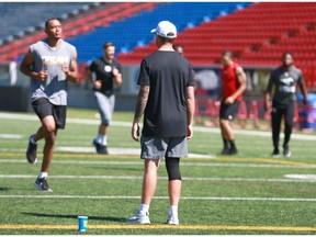Calgary Stampeder QB Bo Levi Mitchell observes practice in Calgary on Friday, July 13, 2018 wearing a sleeve on his right knee. Mitchell took an awkward hit on the same knee on Thursday night against Ottawa and didnt participate in the team run down.Jim Wells/Postmedia