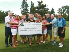 Willow Park Charity Classic Tournament committee members and executives from the Calgary Counselling Centre hold a cheque after raising over $700,000 the Willow Park Charity Classic golf tournament at Willow Park Golf and Country Club in Calgary on Thursday, July 19, 2018. The Jim Wells/Postmedia
