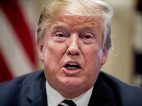 President Donald Trump speaks to members of the media as he meets with members of Congress in the Cabinet Room of the White House, Tuesday, July 17, 2018, in Washington.