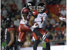 Calgary Stampeders Lemar Durant (1) celebrates his touchdown with Kamar Jorden (88) as Ottawa Redblacks Loucheiz Purifoy (5) walks off, during second half CFL action in Ottawa on Thursday, July 12, 2018.