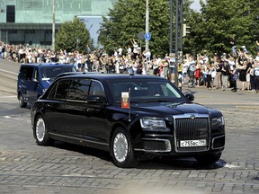 The motorcade and Kortezh limousine carrying the Russian President Vladimir Putin pass the Finnish Parliament in Helsinki, Finland, Monday, July 16, 2018.
