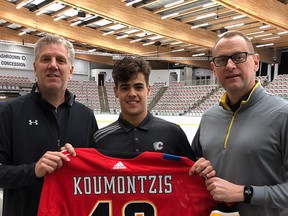 Draft pick Demetrious Koumontzis gets his commemorative jersey from chief scout Todd Button and GM Brad Treliving this week at WinSport.
