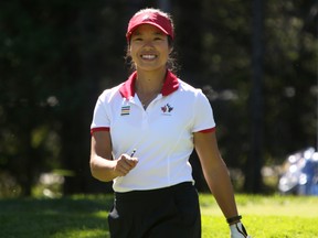 Calgarian Jaclyn Lee is all smiles after her shot from the first tee during round 2 of the Canadian Pacific Women's Open at Priddis Greens Golf and Country Club west of Calgary, Alta., August 26, 2016. Leah Hennel/Postmedia
