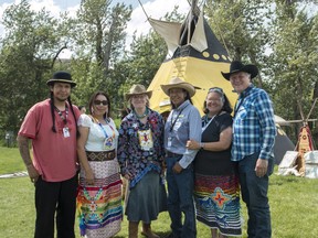 Nathan Meguinis, Trissa Meguinis, Hon. Carolyn Bennett, tipi owner Michael Meguinis Jr., Violet Meguinis and Hon. Richard Feehan are pictured in front of the Meguinis tipi before the opening ceremonies of Indian Village at the 2018 Calgary Stampede on Friday, July 6, 2018. KERIANNE SPROULE/POSTMEDIA