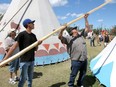 People chipped in to help rebuild teepees at Indian Village after a windstorm forced them to be taken down  Saturday, July 14, 2018. Dean Pilling/Postmedia