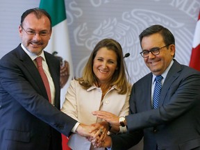 Mexico's Foreign Minister Luis Videgaray, left, Canada's Foreign Affairs Minister Chrystia Freeland, center, and Mexico's Secretary of Economy Ildefonso Guajardo pose for a photo during a joint news conference about ongoing renegotiations of the North American Free Trade Agreement (NAFTA) in Mexico City, Wednesday, July 25, 2018.