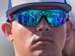 Toronto Blue Jays pitchers are reflected in the glasses of closer Roberto Osuna at spring training in Dunedin, Fla. on Feb. 20, 2018