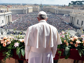 Pope Francis addresses a crowd from the main balcony of St. Peter's Basilica, at the Vatican.