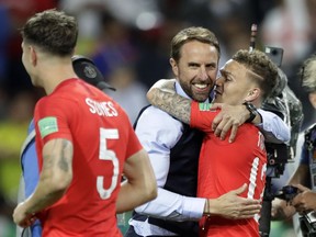 England head coach Gareth Southgate, center, hugs Kieran Trippier after the round-of-16 match between Colombia and England at the 2018 World Cup in Moscow on July 3, 2018.