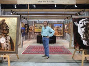 Paul Van Ginkel poses with some of his paintings in the Western Showcase at the Calgary Stampede on Thursday July 5, 2018. Leah Hennel/Postmedia