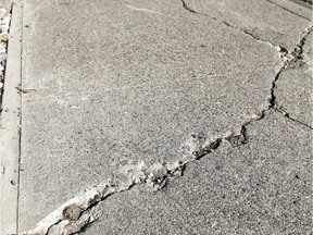 Reader says cracked sidewalks, such as this one, should be repaired more quickly.