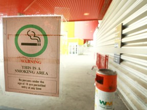 A sign is posted on a glass partition at the Scotiabank Saddledome in Calgary on Tuesday, July 3, 2018. In an email from the Calgary Sports and Entertainment Corporation to Flames season ticket holders, the organization announced that as of Canada Day smoking will be banned inside and outside the Scotiabank Saddledome, and exiting and re-entering the arena will no longer be permitted during events, sporting or non-sporting. Jim Wells/Postmedia