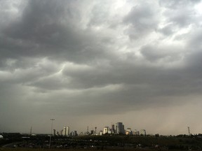 Thunderstorm gathers over downtown Calgary, looking west, on July 23, 2018.