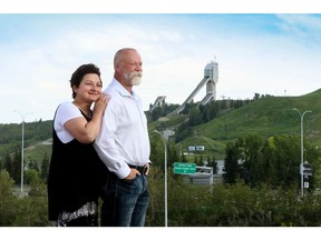 Rochelle and Tim Bliek on the Greenwich land with striking views of WinSport behind them.