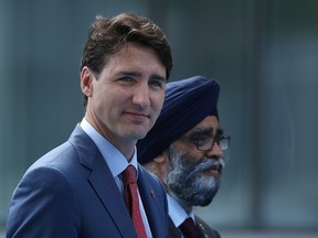 Prime Minister Justin Trudeau (L) and Defence Minister Harjit Sajjan arrive at the 2018 NATO Summit at NATO headquarters on July 11, 2018 in Brussels, Belgium.