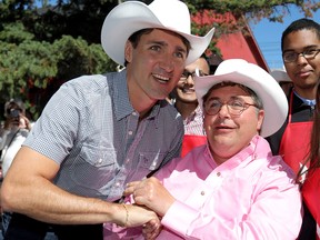 Justin Trudeau greets MP Kent Hehr during Hehr's Annual Stampede Breakfast at the Sunalta Community Centre in Calgary on July 7, 2018.