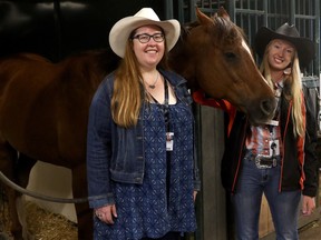 Labour Minister Christina Gray and summer temporary employment program worker Jessica Melville in the chuckwagon barn.