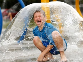 Brandon Wall,9, cools down at the water park in Rotary Park as temperatures soared in Calgary on Monday July 9, 2018. Darren Makowichuk/Postmedia