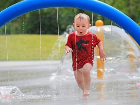 Two year-old Hunter has some fun cooling off in the water park at Rotary Park in Calgary on Thursday July 19, 2018.