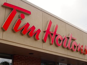 In this file photo taken on August 27, 2014 the sign over a Tim Hortons coffee-and-donut shop is viewed in Magog, Quebec.