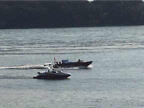 The allegedly stolen boat, right, on the St. Lawrence River near Old Montreal.