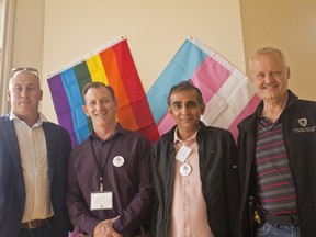 Kelly Ernst, director for the director for the LGBTQ+ Newcomers Services, middle left, stands with Sgt. Eyvi Smith, with the Integrated National Security Enforcement Team, left, Indian refugee Devang Sampat, middle right, and R/Cst. Chris Griffin with INSET, right on August 25th, 2018. The men were all at the launch for the End of the Rainbow Foundation and Rainbow Railroad Station in Calgary. (Zach Laing / Postmedia Network)