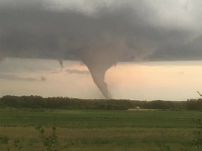 Number released by the Insurance Bureau of Canada (IBC) show property owners in Alberta, Saskatchewan and manitoba were hit hard by storms between June and August. Pictures taken by Bryan Mozdzen show a tornado touching down near Alonsa, Manitoba, on Friday, Aug. 3, 2018.