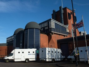 In this file photo taken on December 17, 2016 prisoner transport vans arrive and depart from the entrance to HMP Birmingham in Winson Green, Birmingham, central England.