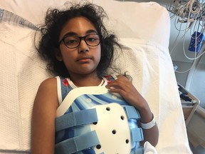 Mehak Minhas, 10, is seen in her hospital bed at the Alberta Children's Hospital in Calgary on Thursday, August 2, 2018. A spinal injury has rendered her unable to feel or move her legs, and she also fractured her left leg and right arm.