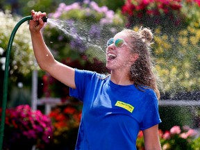 Breanne Schweitzer from Plantation Garden Centre takes a minute to cool down in Calgary on Tuesday, August 7, 2018.