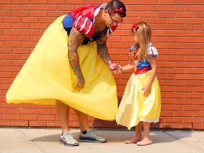 Ryan Bourquin and his daughter Winnie, 6, take a break from a book-signing event at Chapters (Sunridge) in northeast Calgary on Sunday, August 12, 2018. (Jim Wells/Postmedia)